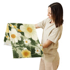 Woman holding a floral blanket with white and yellow flowers on a white background