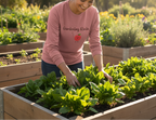 Person wearing a pink 'Gardening Rocks' shirt tending to plants in a garden.