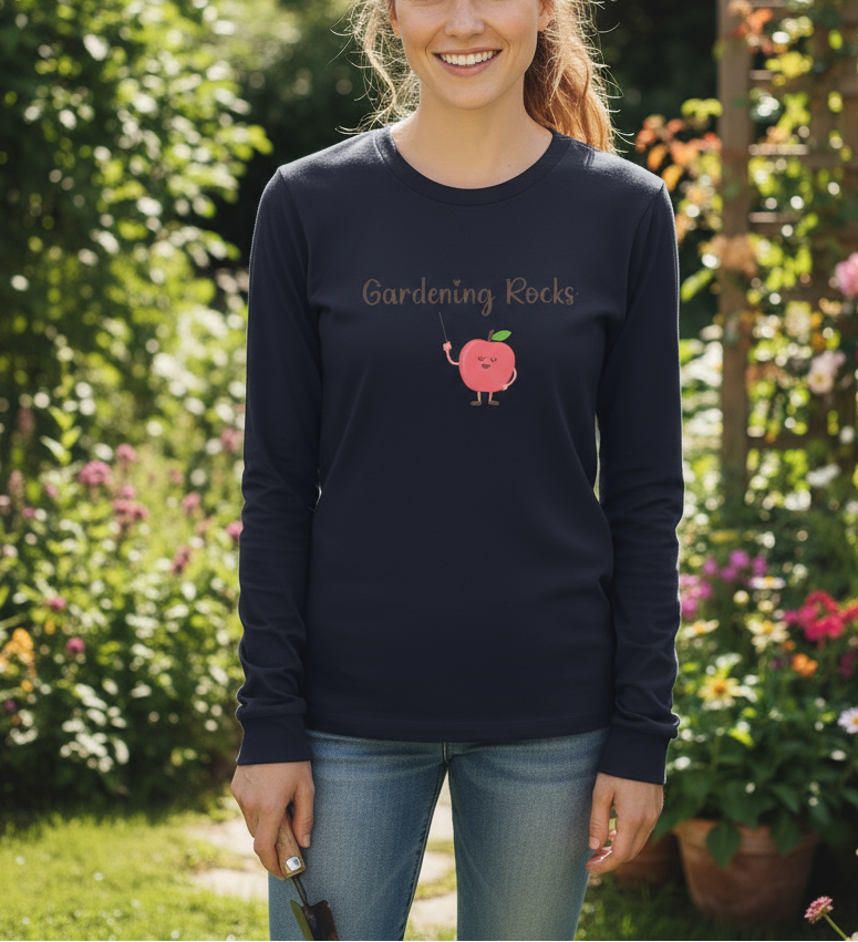 Person wearing a navy long-sleeve shirt with 'Gardening Rocks' and a cartoon apple design, standing in a garden.