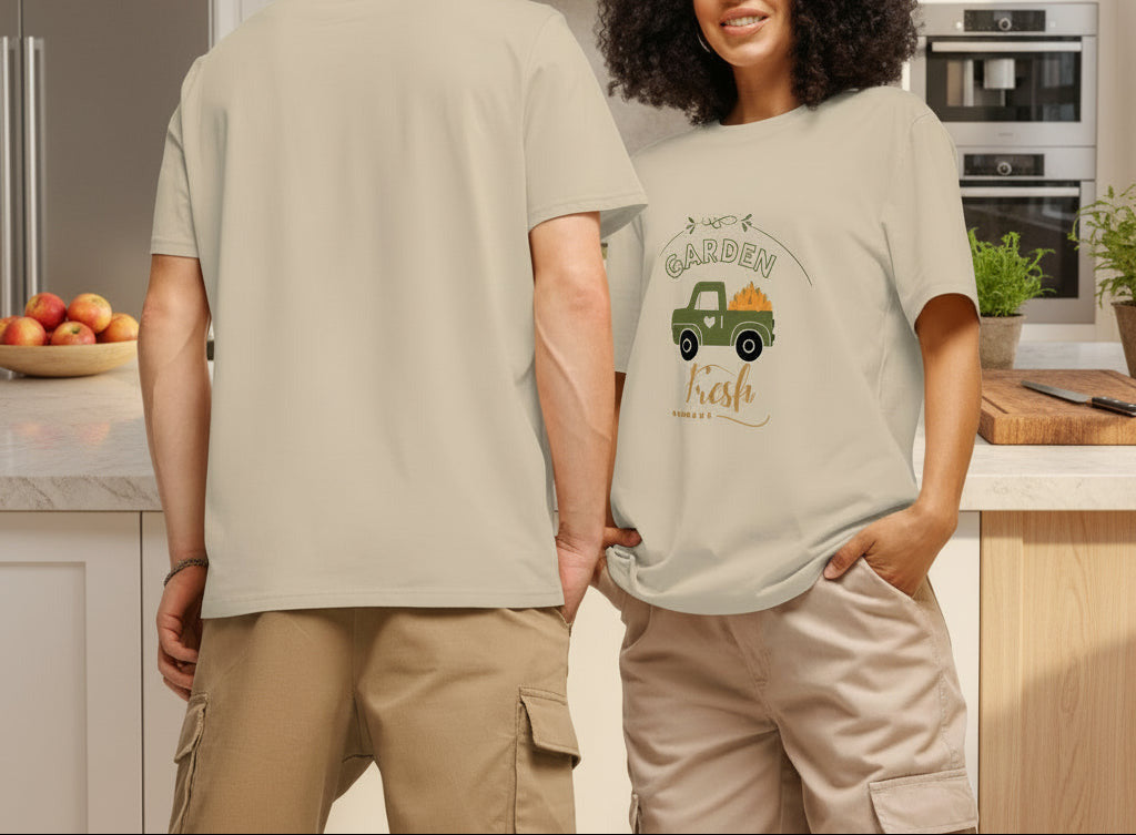 Two people wearing beige t-shirts with a graphic design on a plain background