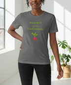 Person wearing a gray t-shirt with a gardening-themed design in a bright room.